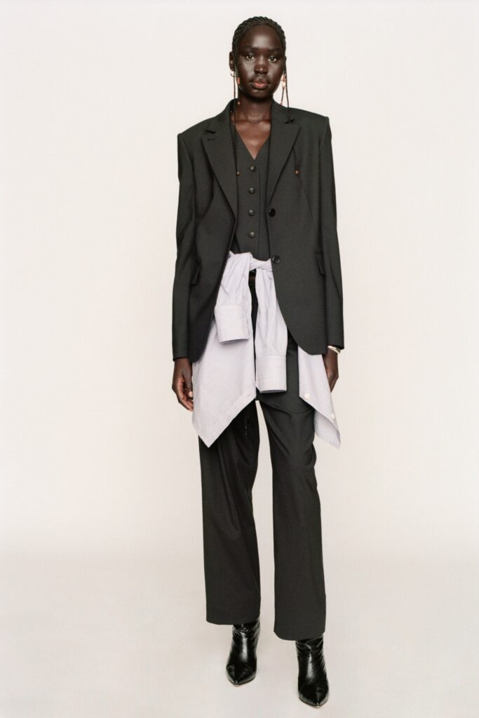 A fitted black blazer with long sleeves and collared design paired with straight-leg pants.