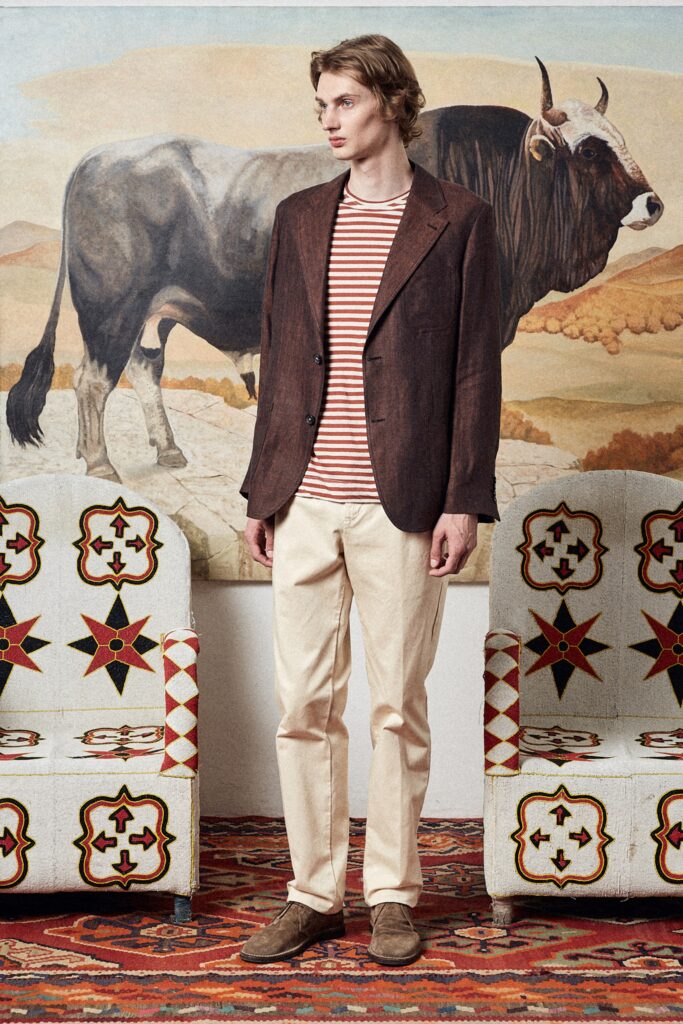 A relaxed brown jacket paired with a long-sleeve striped shirt for a casual look.