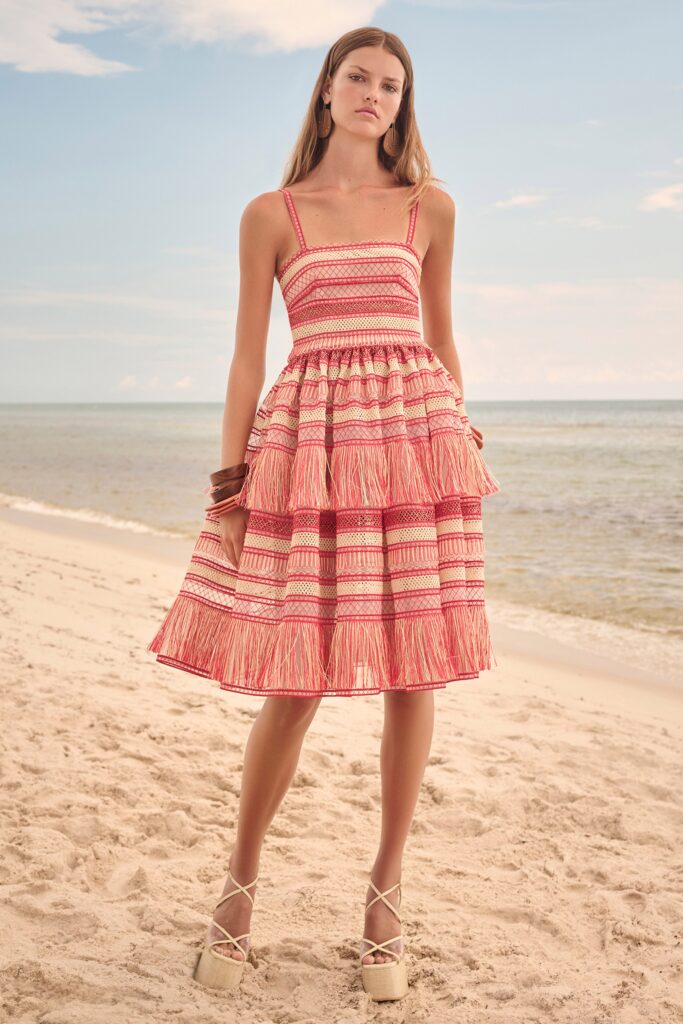 A relaxed red cotton sleeveless dress with a V-neckline and tiered design.