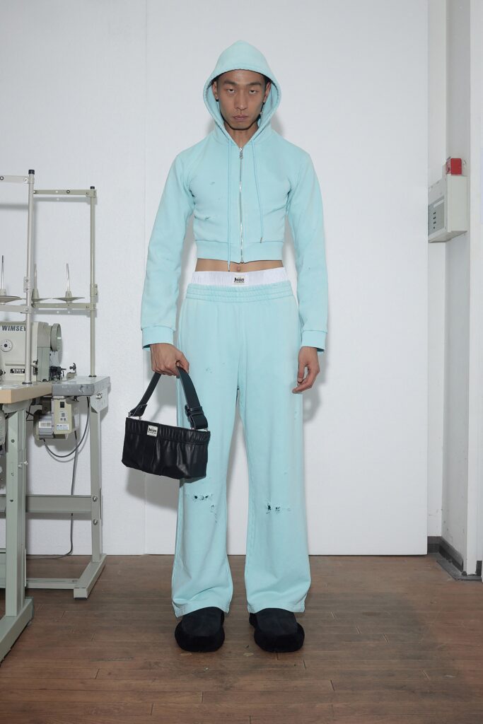A fitted blue hoodie with a hood paired with wide-leg pants for a stylish look.