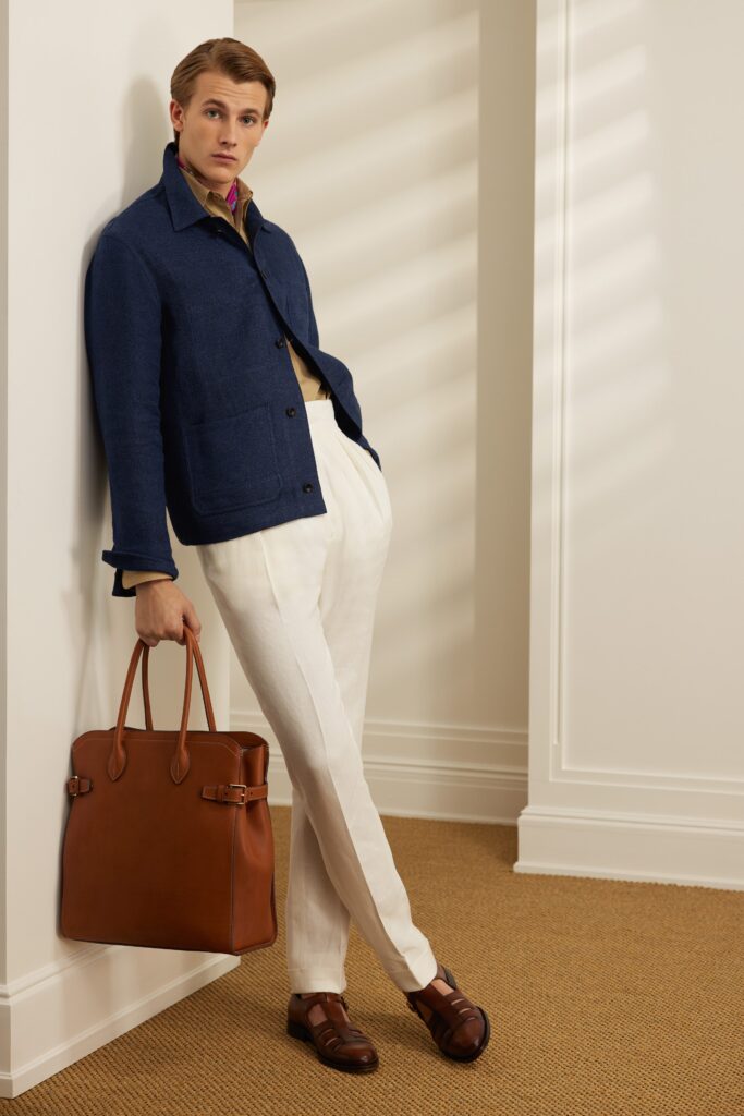A relaxed blue cotton jacket paired with white straight-leg trousers.