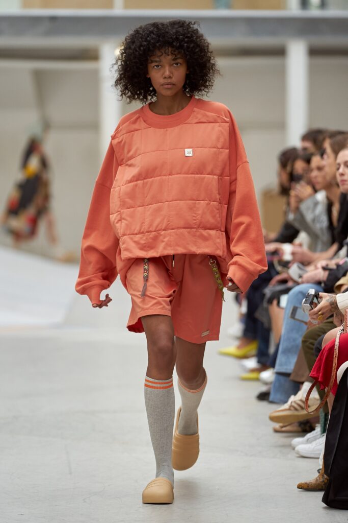 A relaxed orange cotton long-sleeve top paired with matching shorts, featuring a layered design.