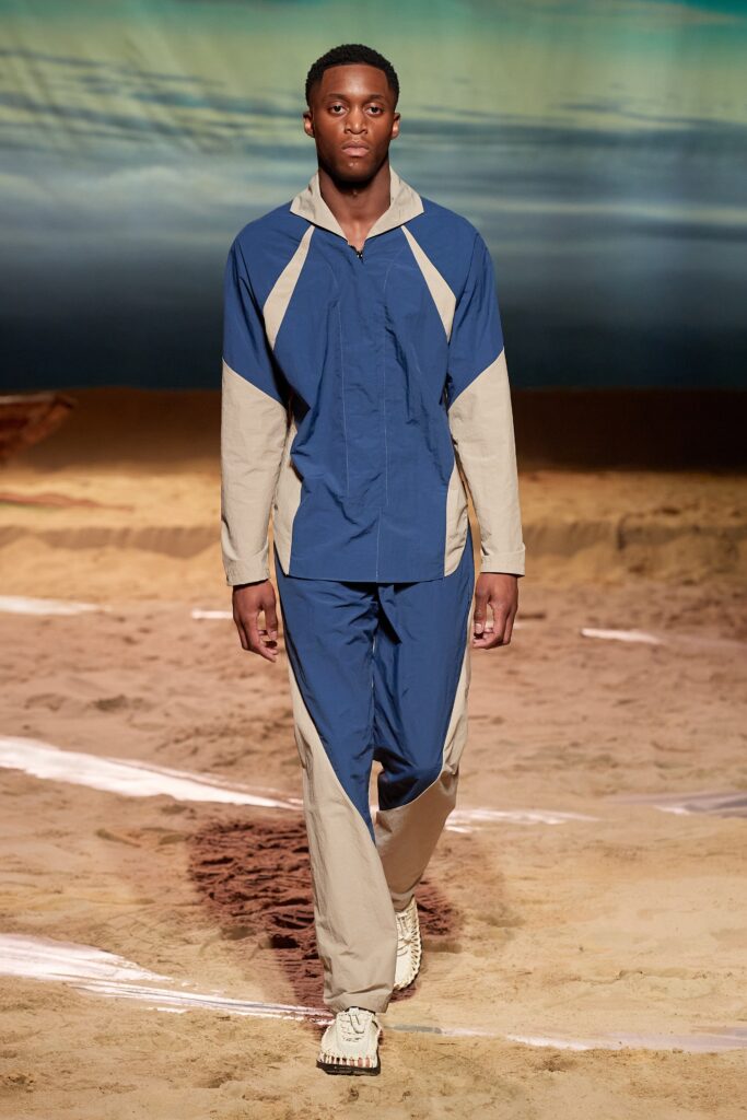 A relaxed fit blue and beige color-blocked jacket paired with matching pants, featuring a hood.