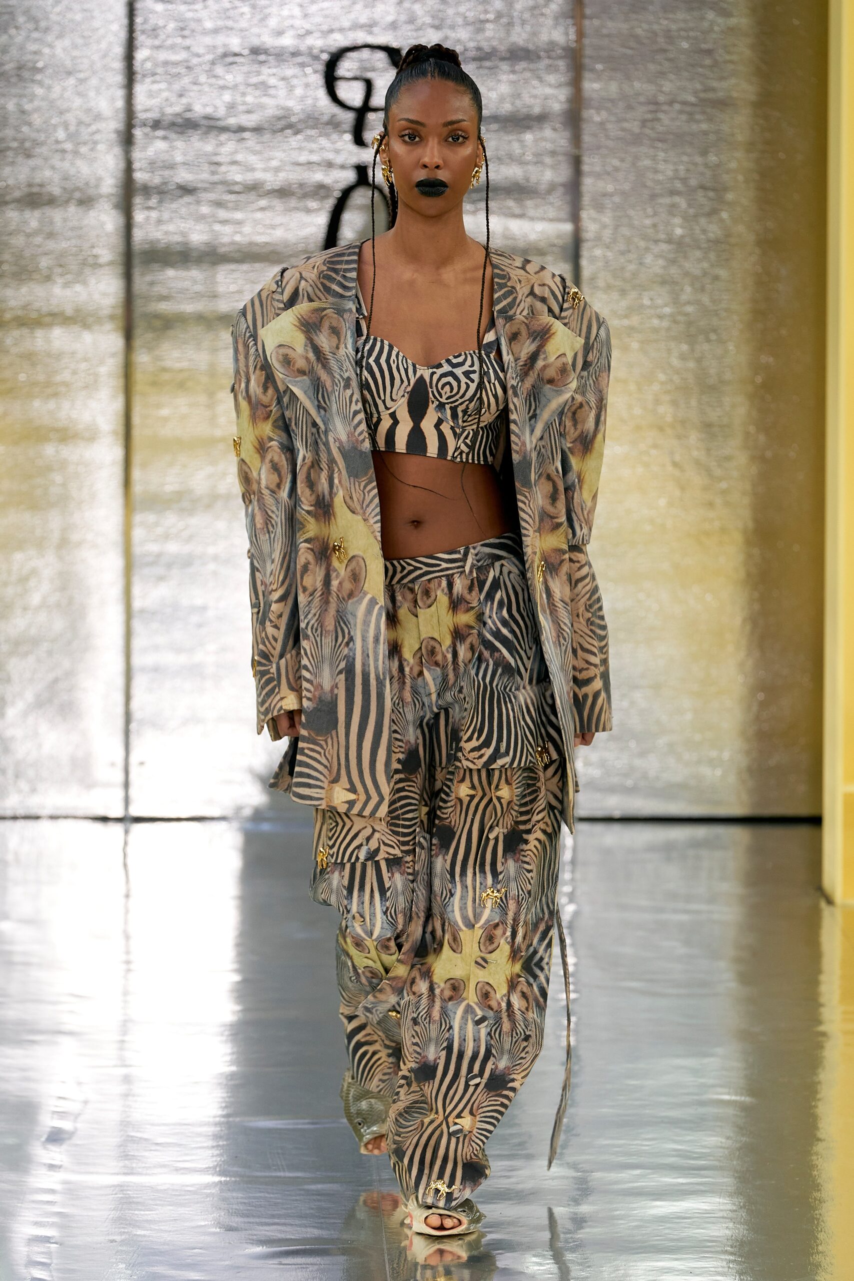 A relaxed fit sleeveless multicolor printed top paired with high-waisted pants.