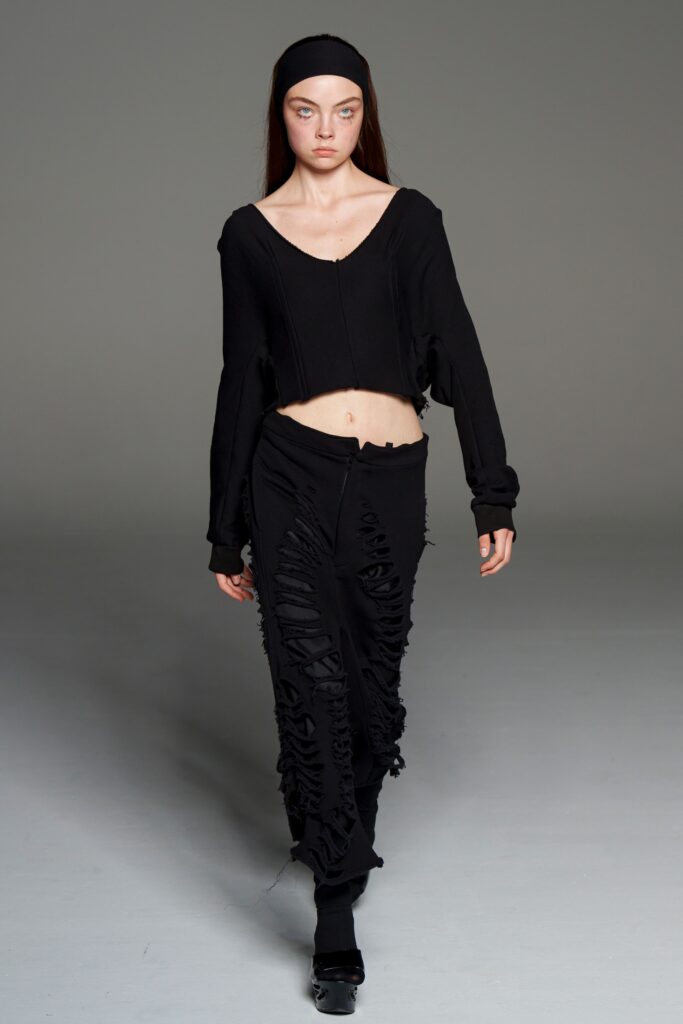 black cropped top and distressed pants