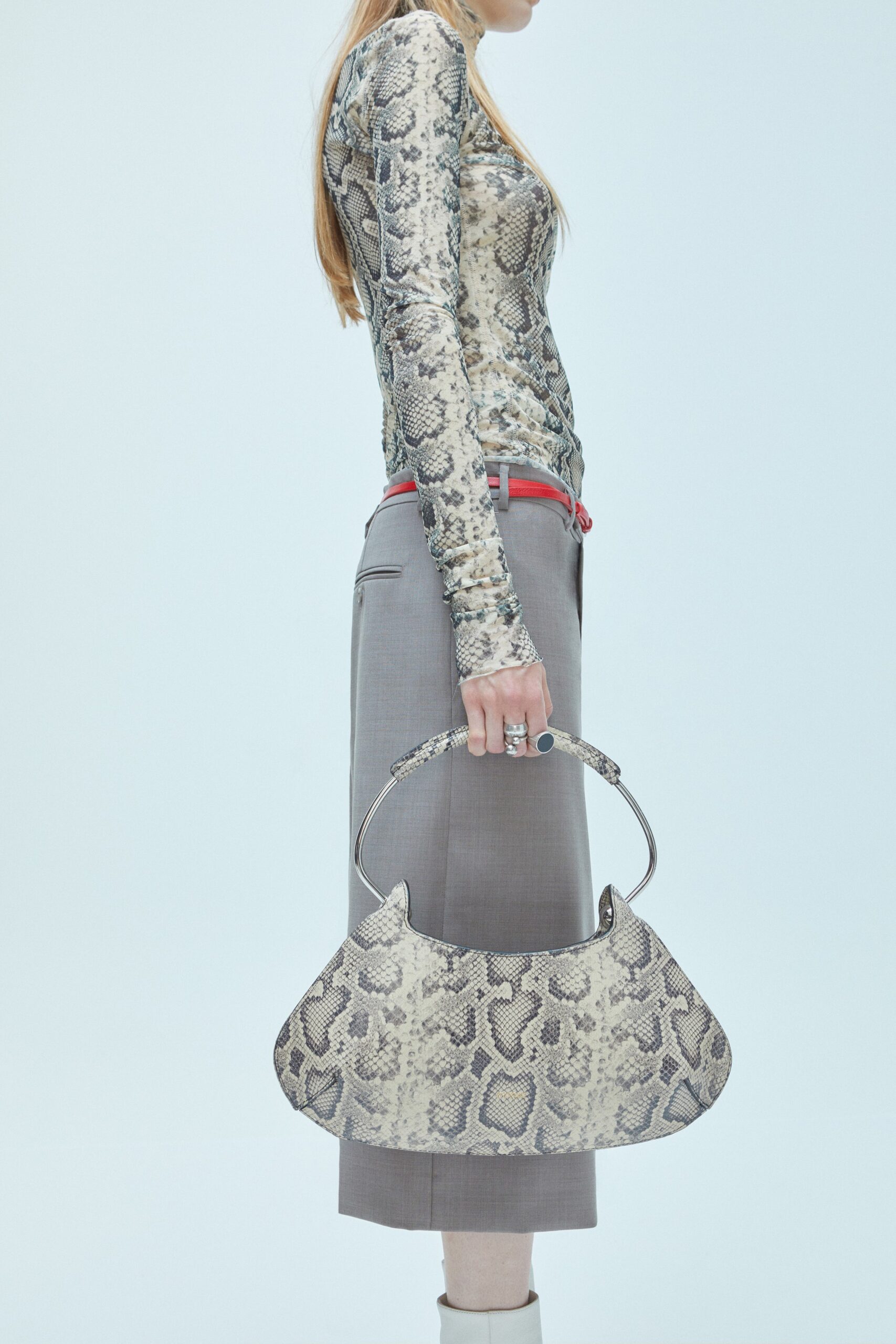 A fitted beige printed long-sleeve top paired with straight-leg gray pants.