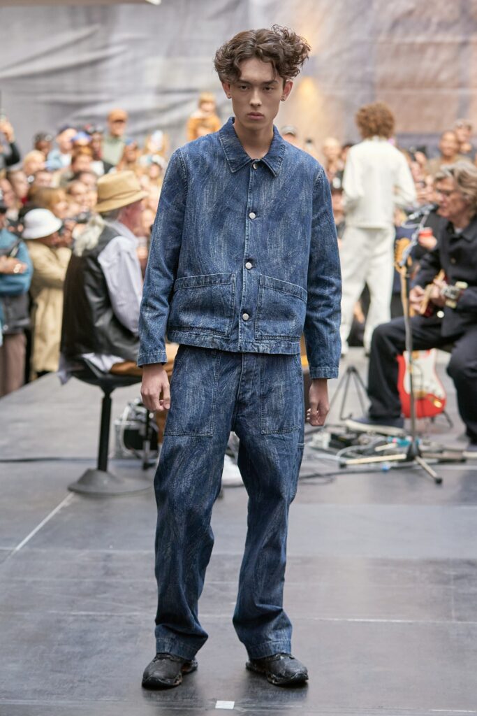A relaxed-fit blue denim jacket with a collared neckline paired with straight-leg denim pants.