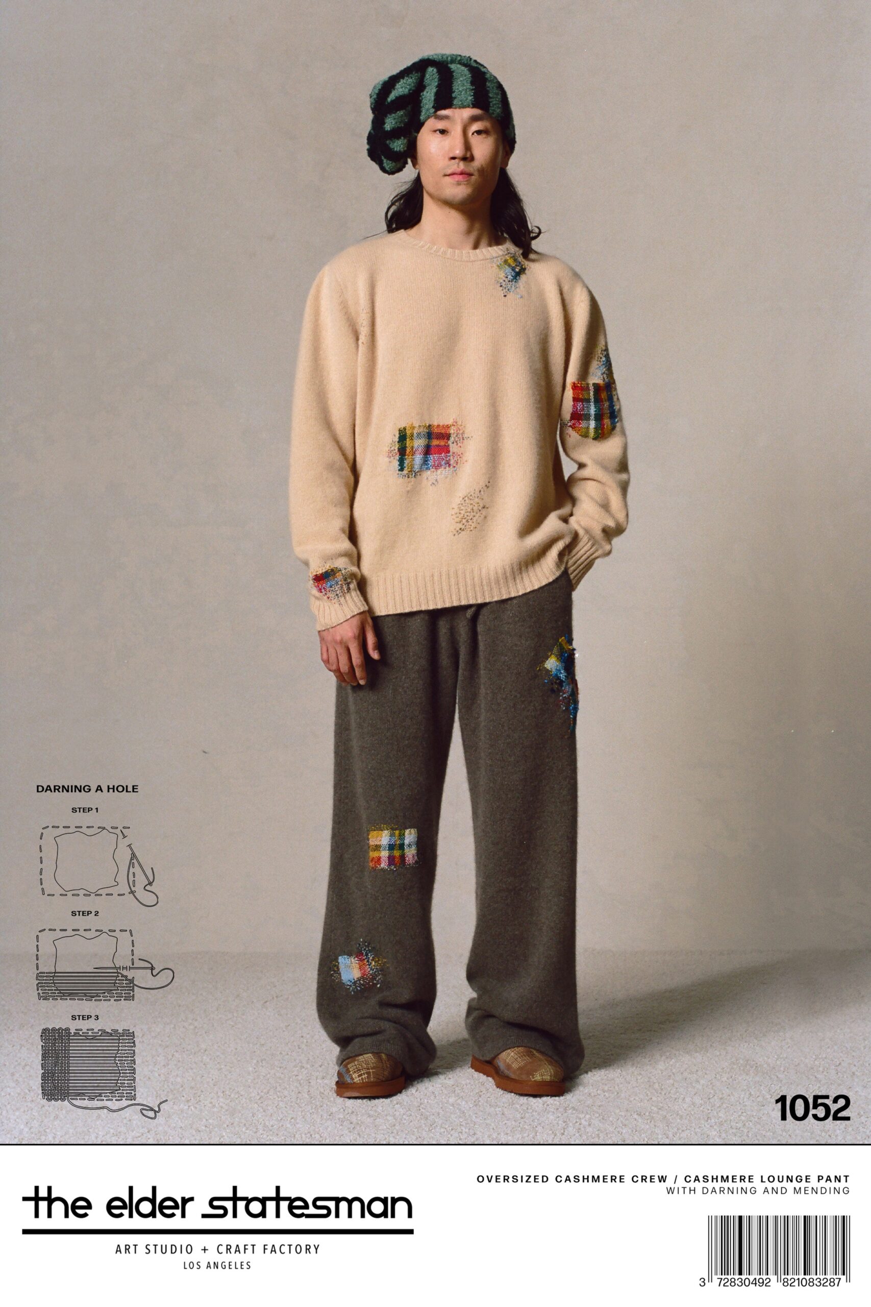 An oversized beige cashmere sweater with embroidered details paired with gray cashmere lounge pants.