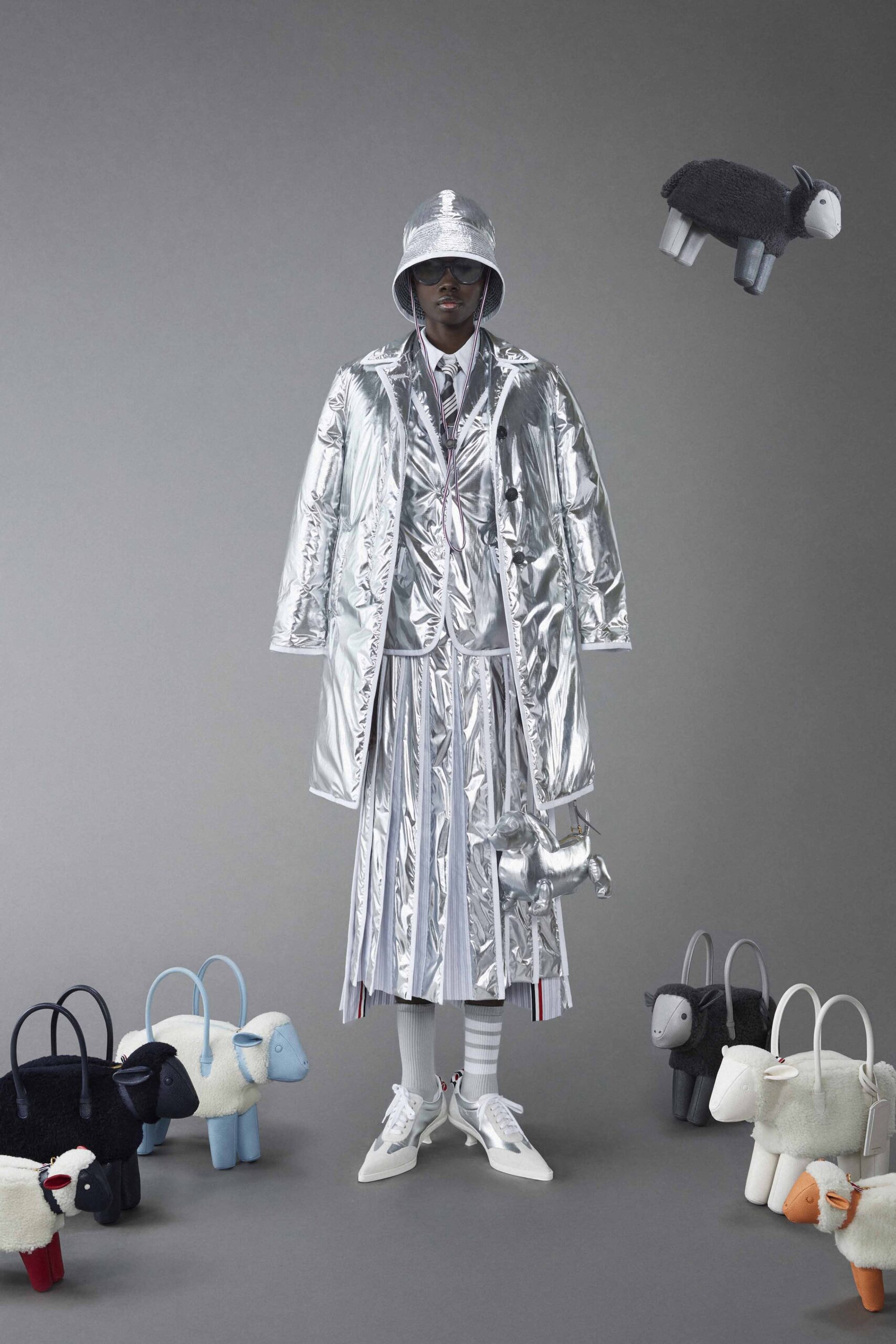 A relaxed silver metallic coat with a collared long-sleeve design and a pleated skirt.