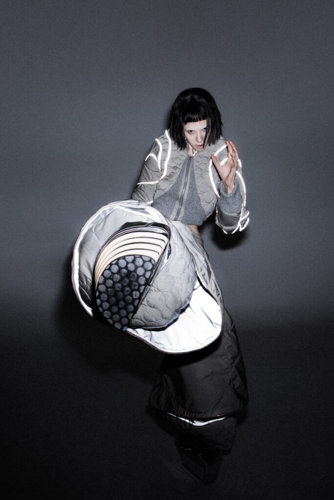 An oversized gray coat dress with long sleeves and a layered, asymmetric design.