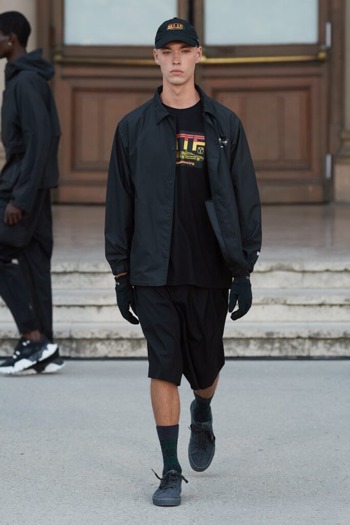 A relaxed black jacket with a collared design paired with matching black shorts.