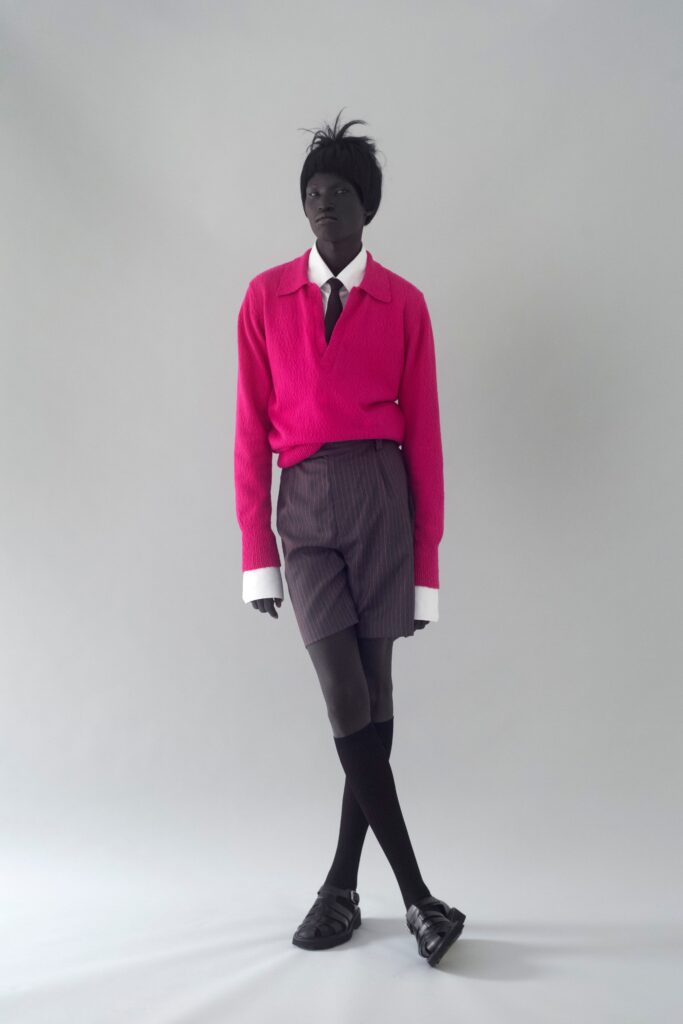 pink fitted sweater with gray tailored shorts