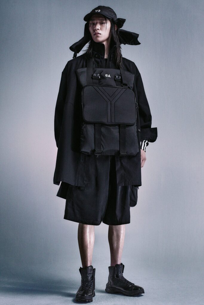 A relaxed black jacket with long sleeves and layered shorts for a contemporary look.