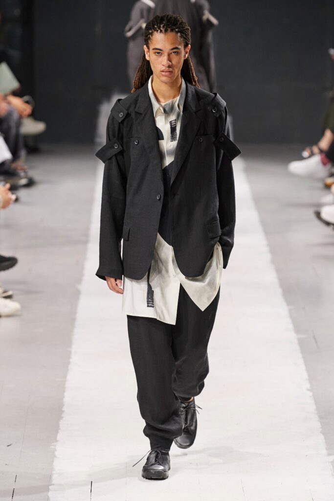 A relaxed black jacket with long sleeves and a collared design paired with matching pants.