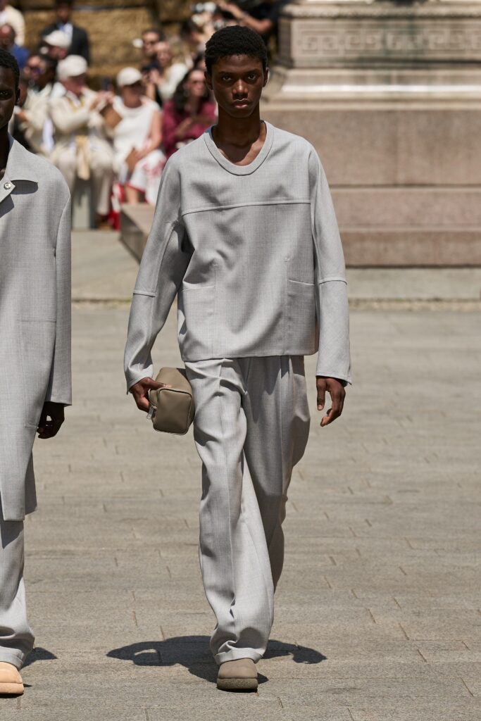 A relaxed gray cotton top with long sleeves and a V-neck, paired with straight-leg pants.