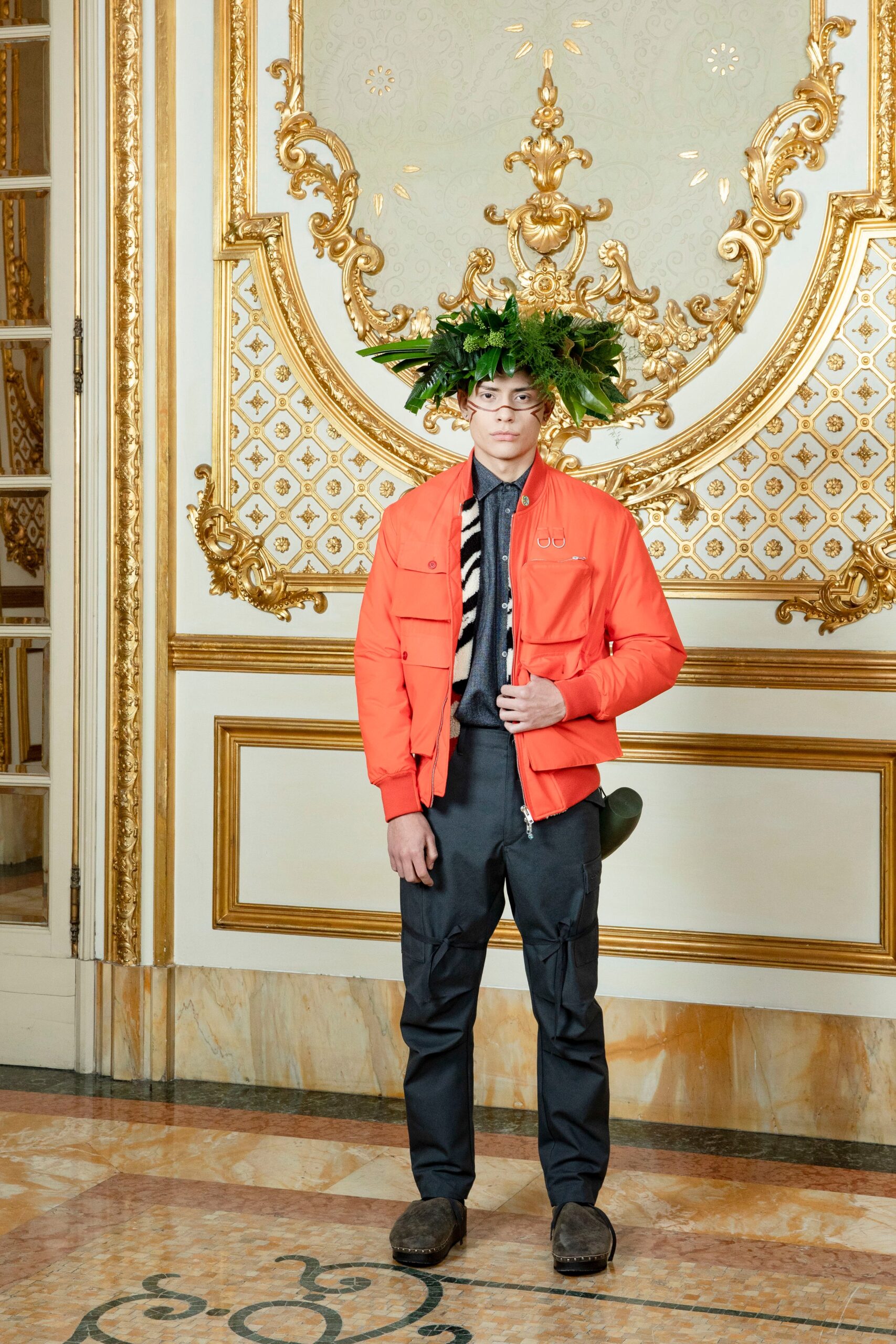 A relaxed-fit orange cotton jacket with long sleeves paired with black pants.