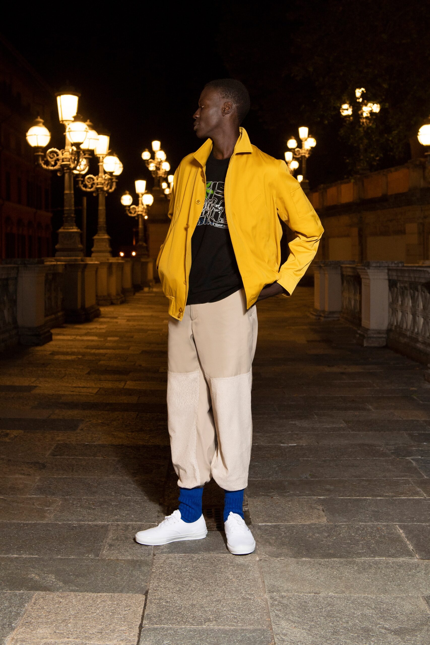 A relaxed yellow jacket paired with beige pants, featuring a zippered design.