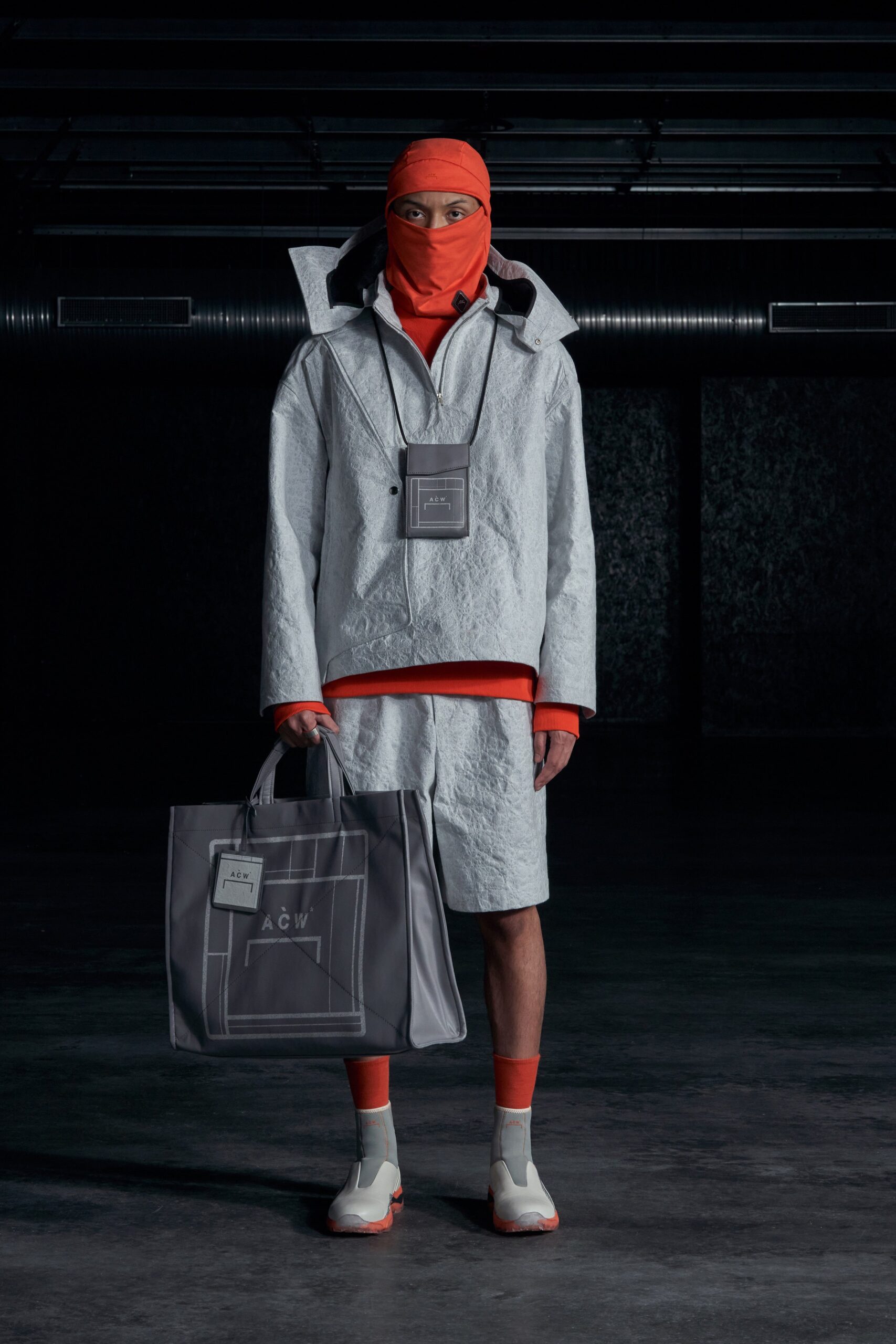 A relaxed gray jacket with long sleeves and a collared design, paired with matching shorts.