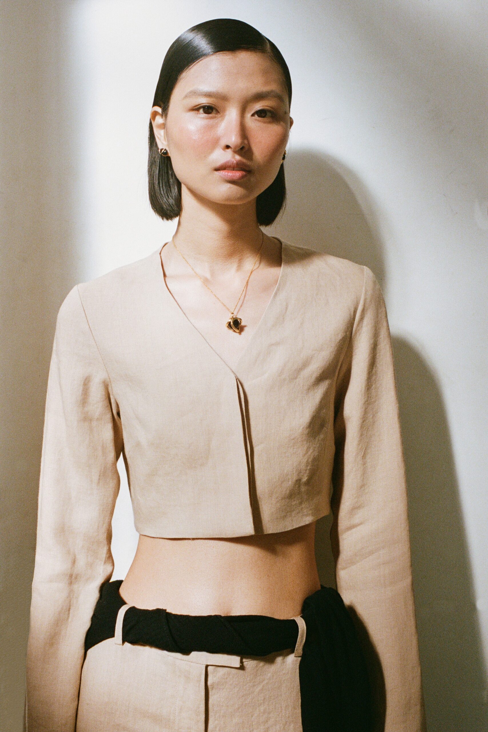 beige linen fitted top and black relaxed pants