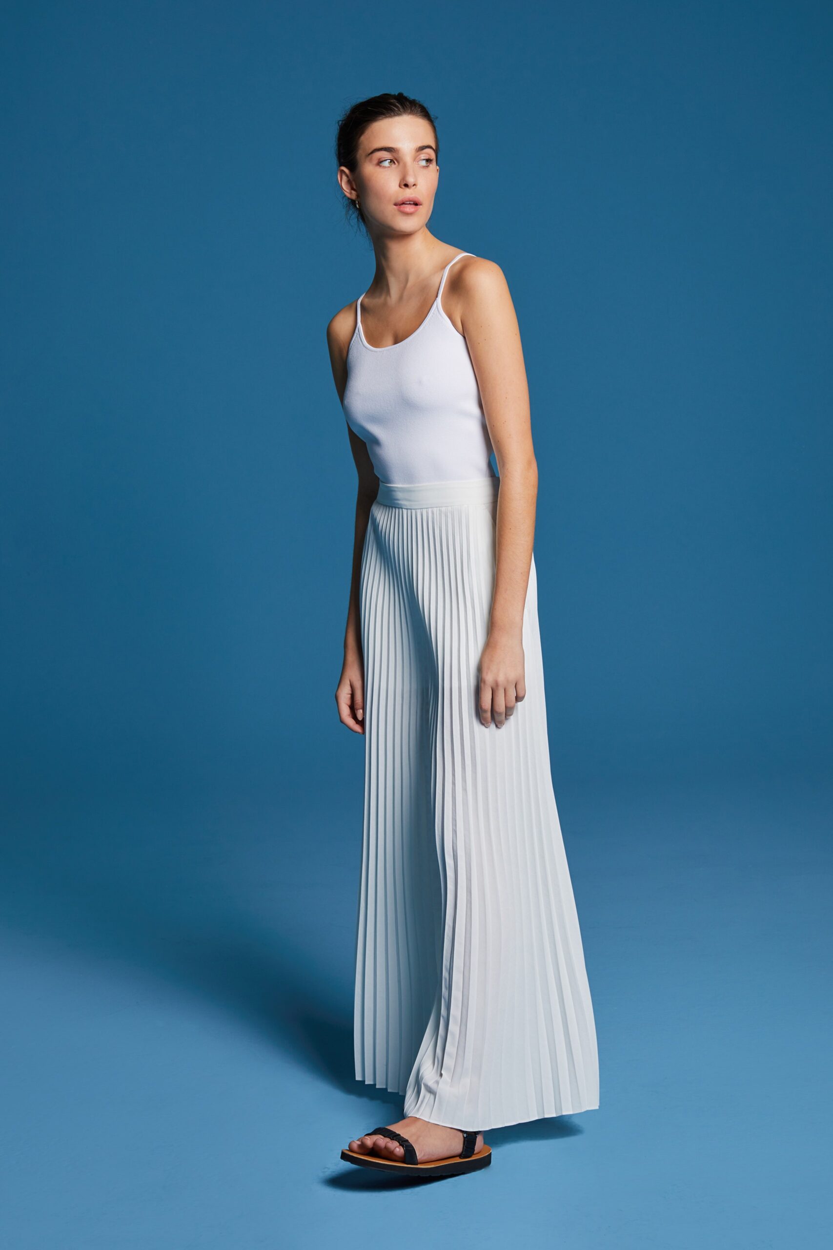 white fitted top with light blue pleated pants