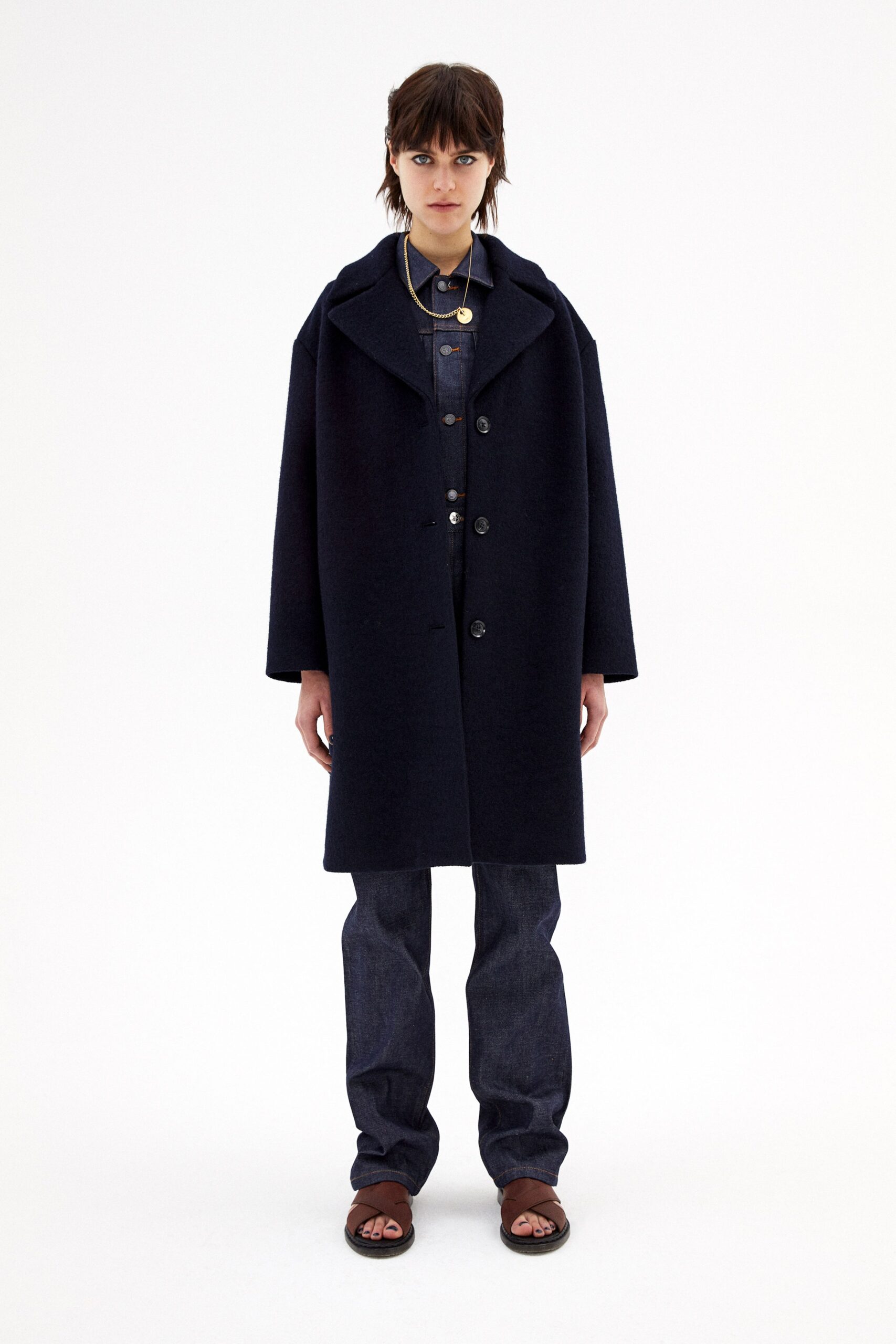 black wool coat and blue denim pants