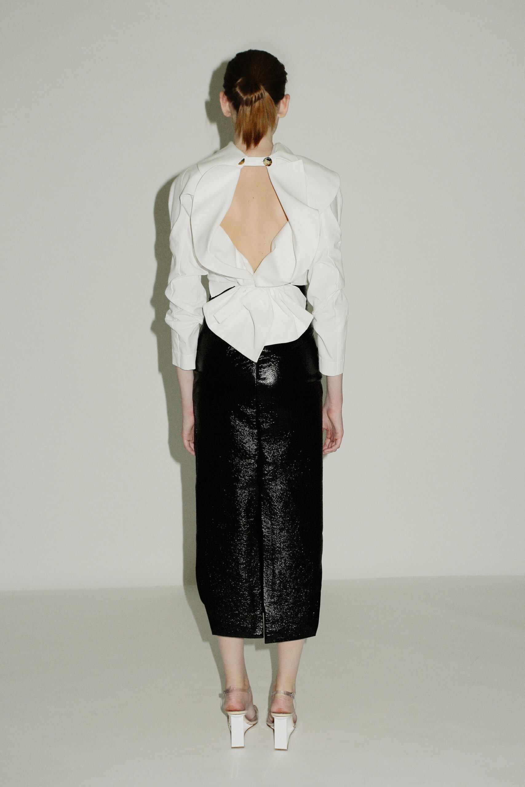 white cotton long-sleeve backless fitted draped blouse