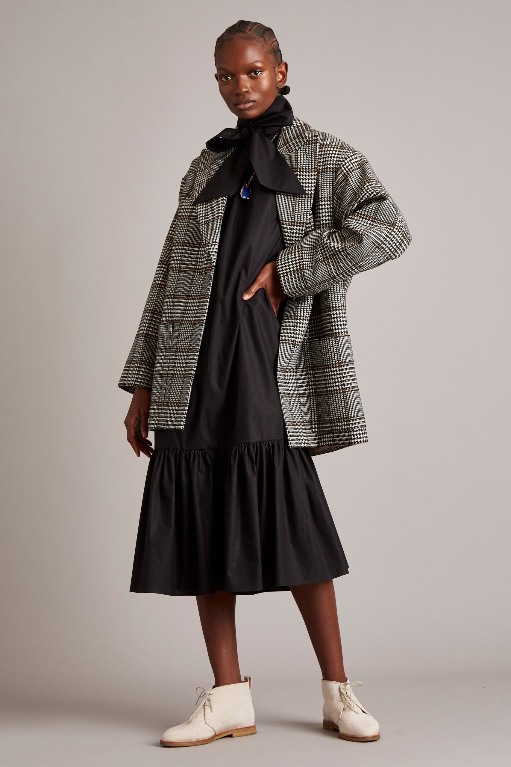 oversized checked coat and black dress