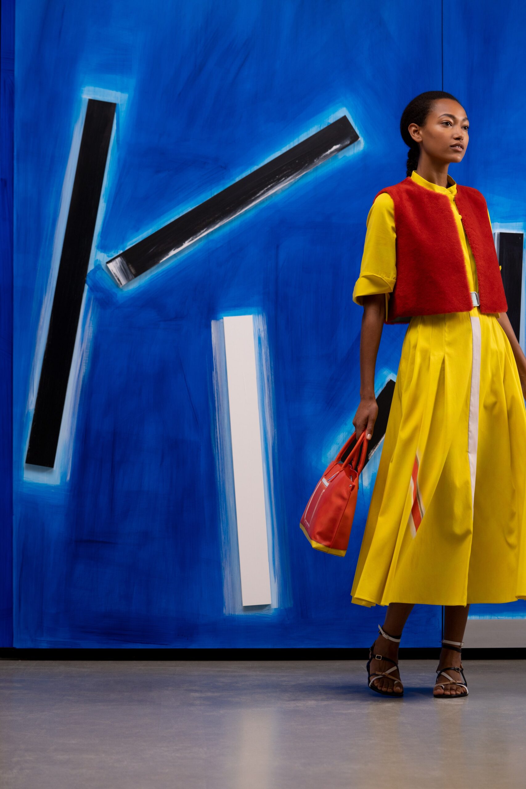 yellow midi dress with red vest