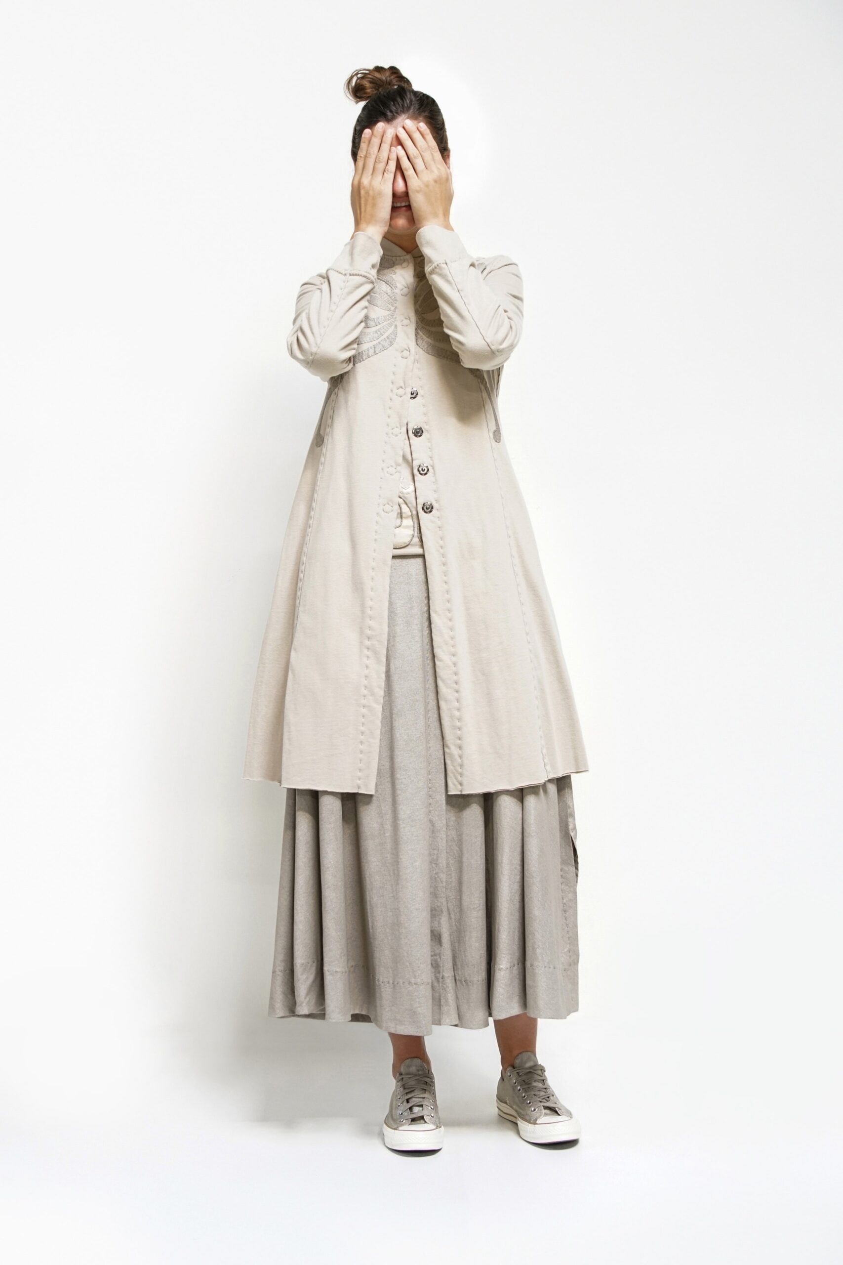 beige coat gray pleated skirt