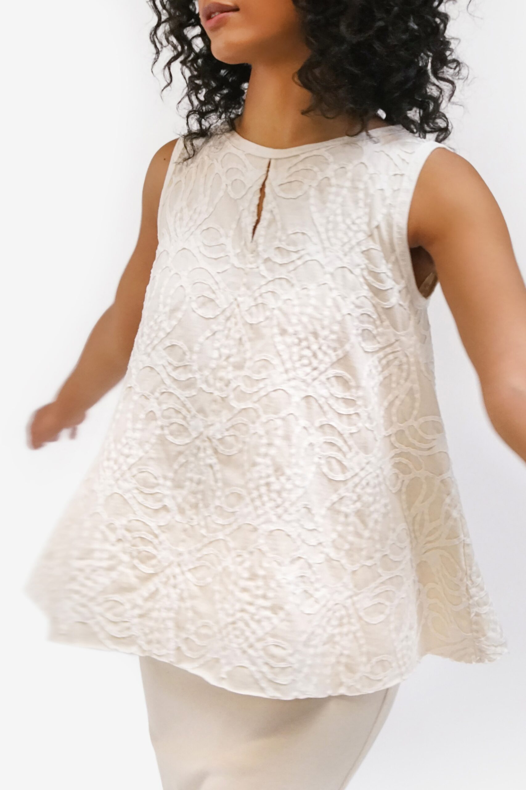 white embroidered top and beige skirt