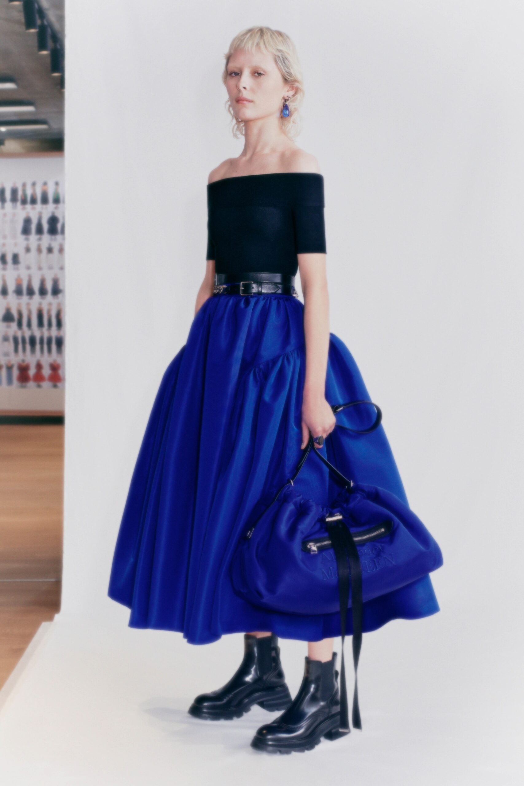 black off-shoulder top blue pleated skirt