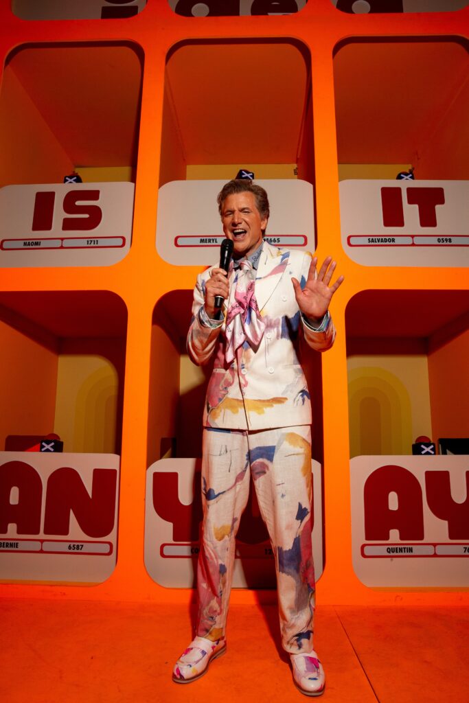 A fitted multicolor suit with long sleeves and a collared design featuring a printed pattern.