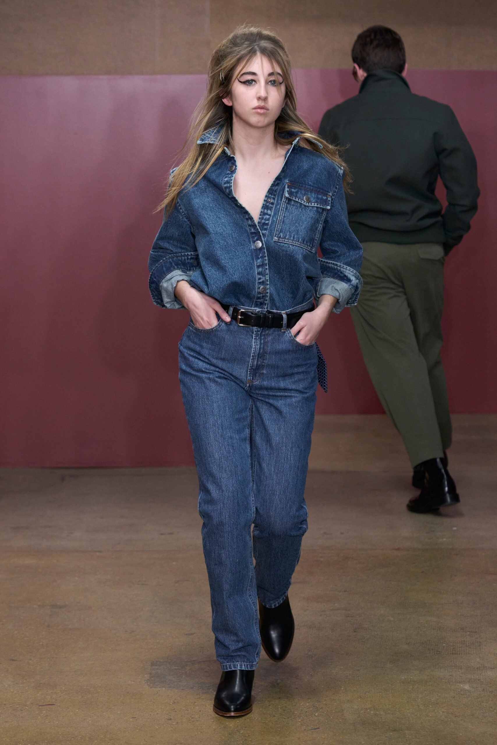 A relaxed fit blue denim jacket with long sleeves and matching denim pants, featuring a collared design.