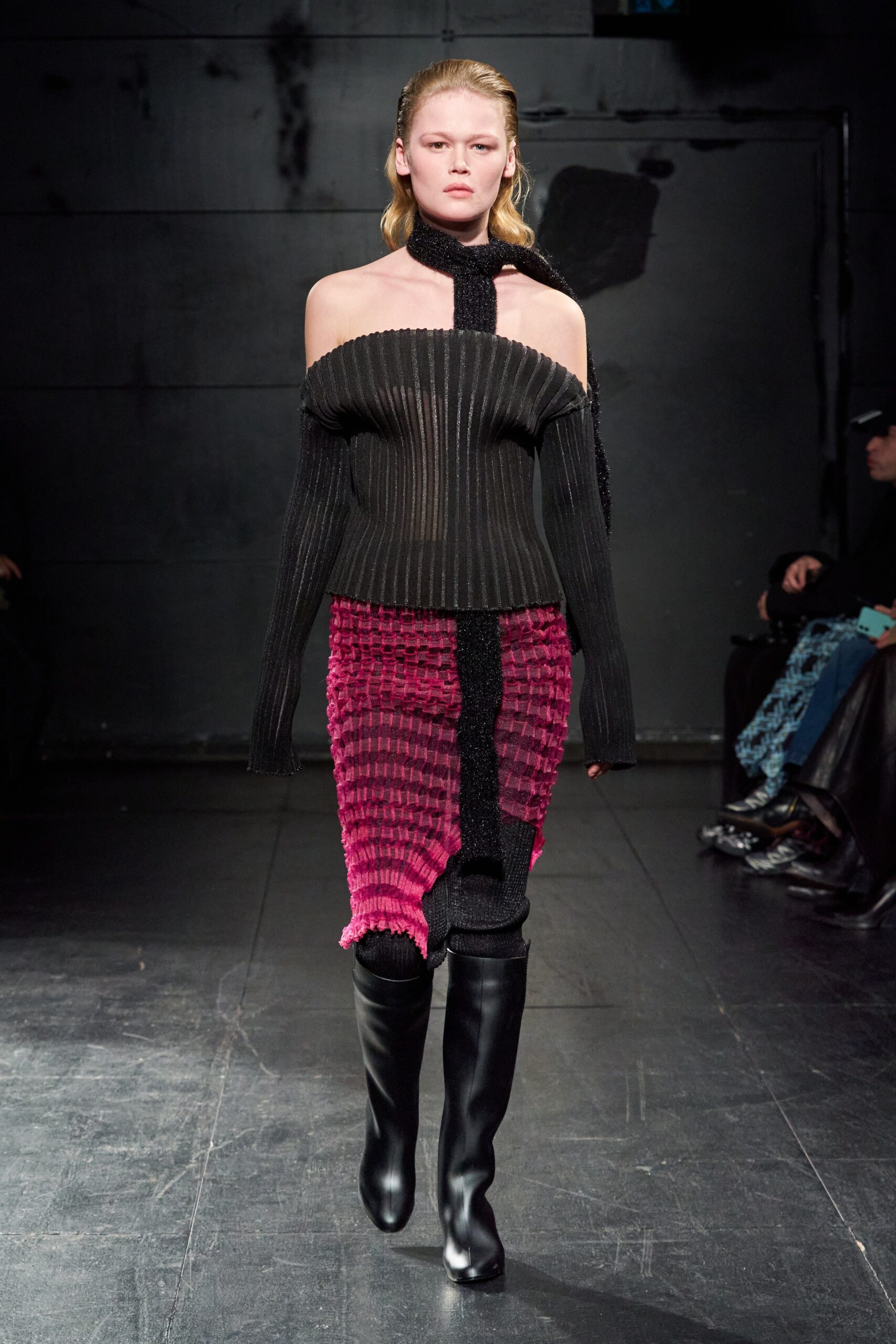 A fitted off-shoulder dress featuring long sleeves, pleated design, and an asymmetric silhouette.