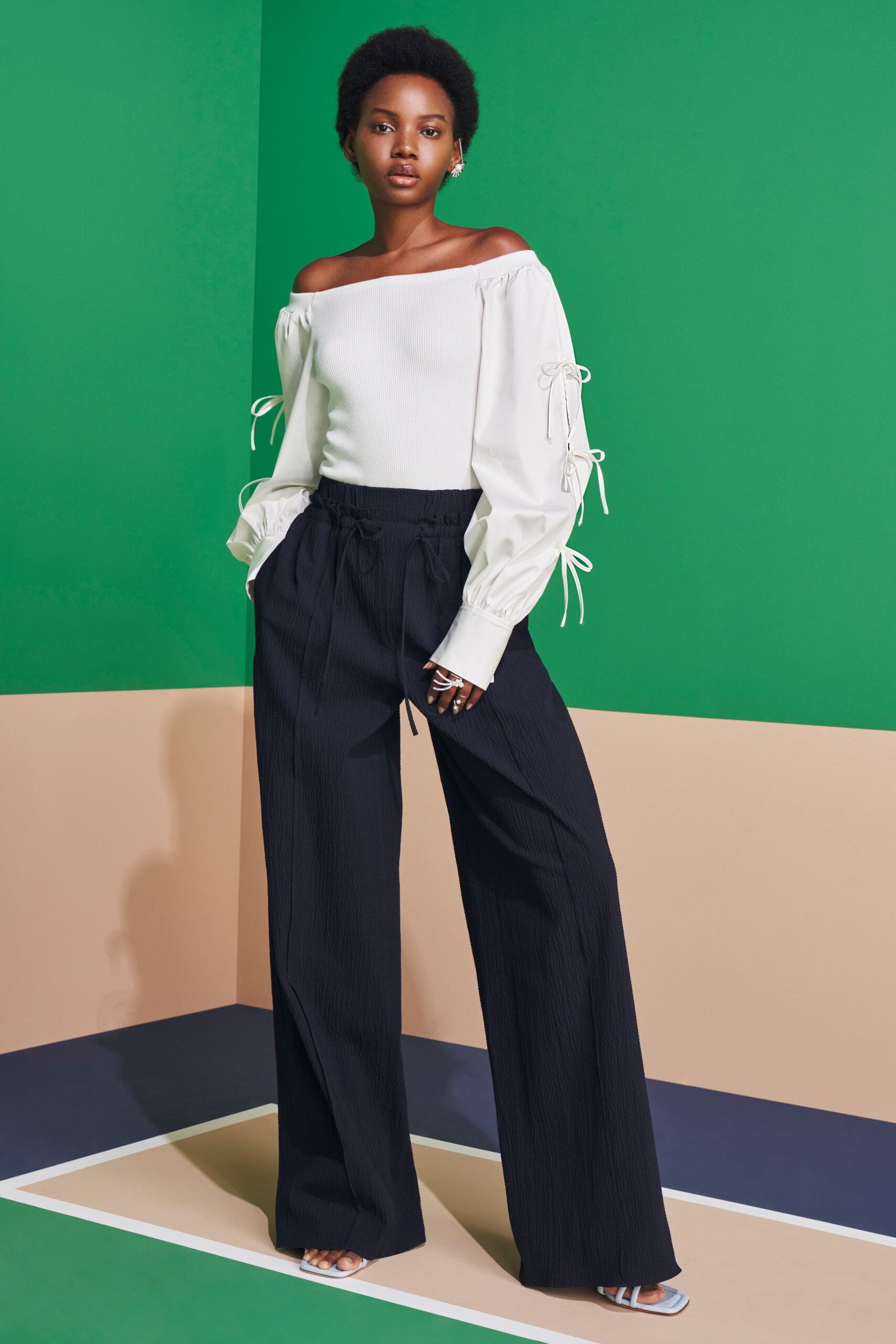 white off-shoulder top with black pants