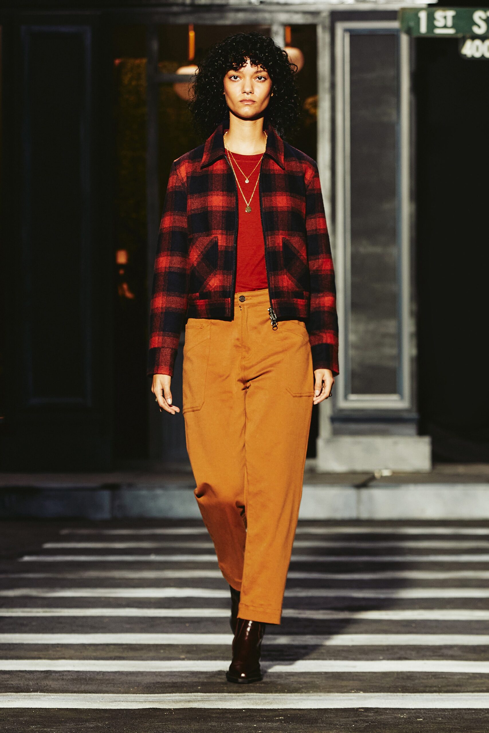 A relaxed red checked jacket paired with brown cotton pants, featuring a collared design.