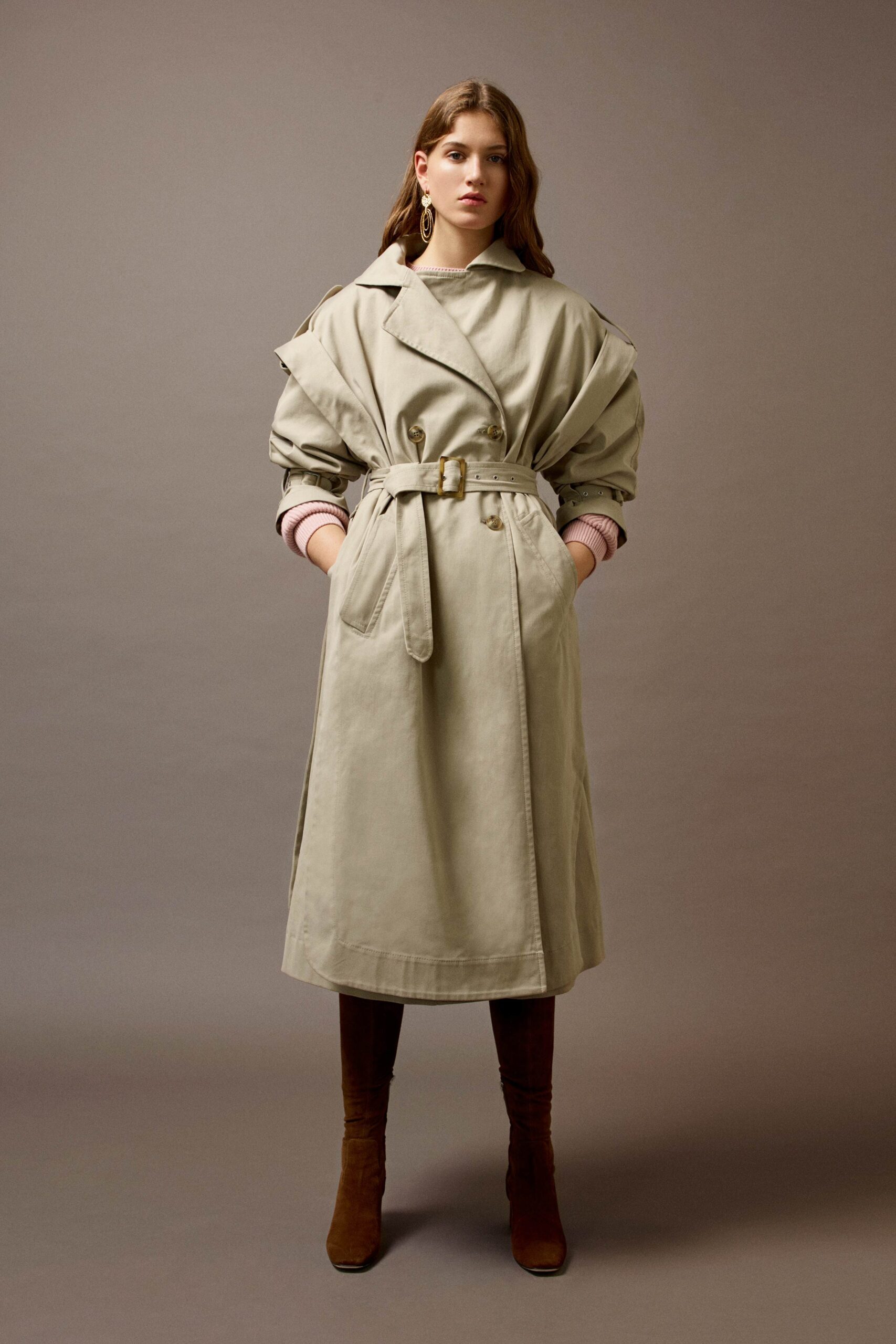 beige relaxed trench coat with brown boots