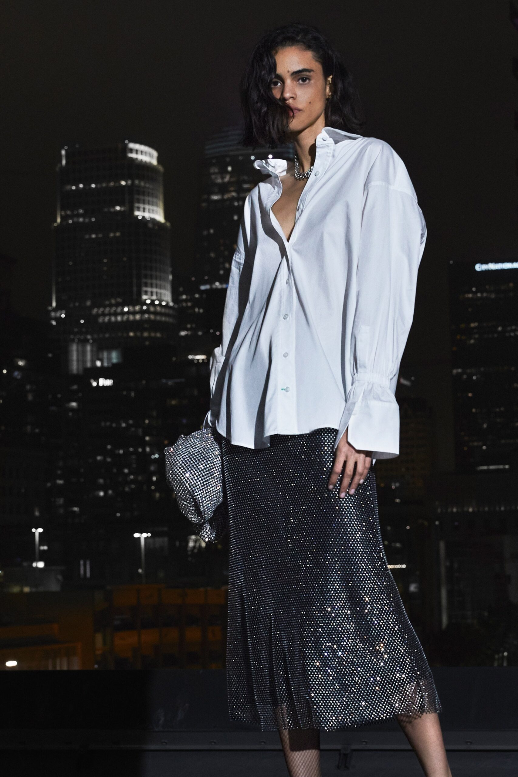 oversized white shirt and black pleated skirt