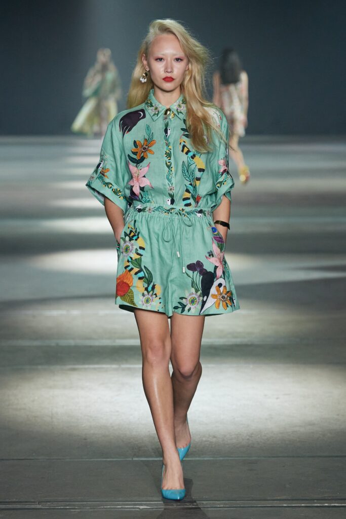 A relaxed green cotton dress with a collared neckline and floral print design.