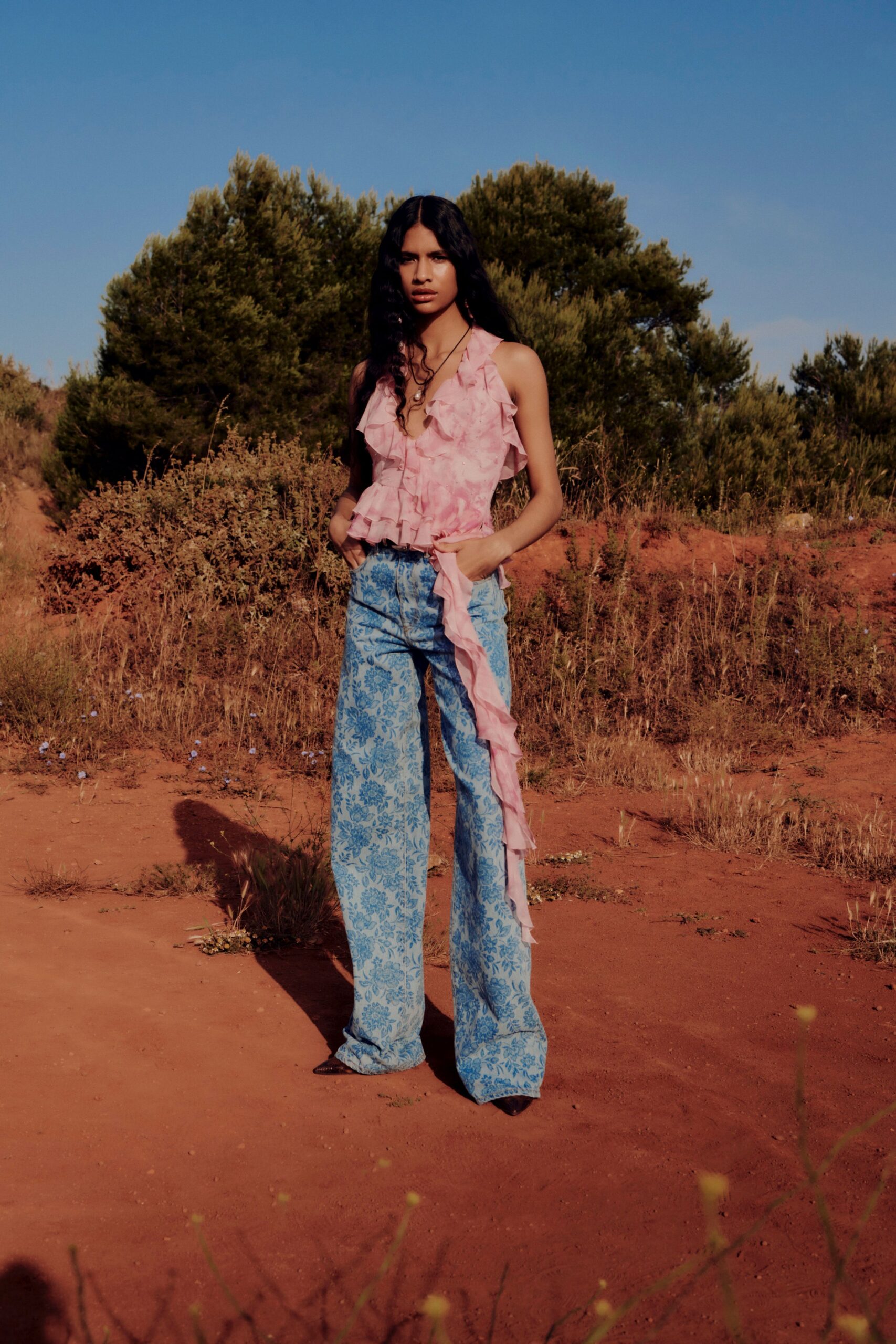 pink ruffled top with blue flared pants