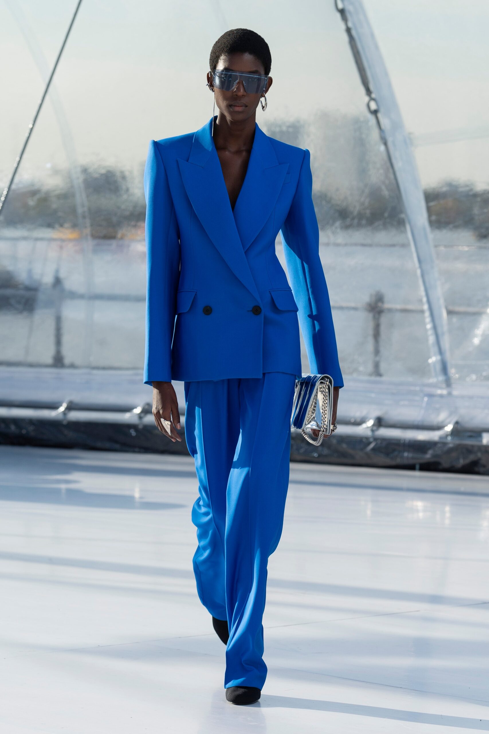 blue tailored suit with clutch