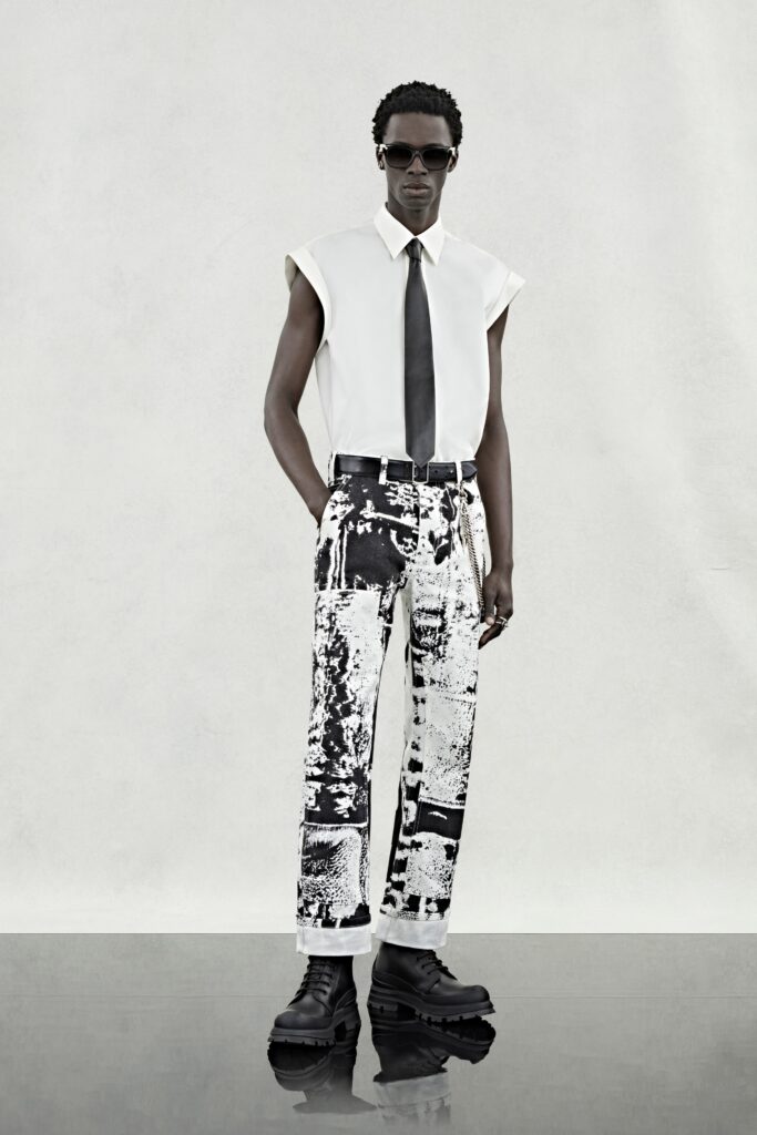 A relaxed white collared shirt paired with black and white printed pants.
