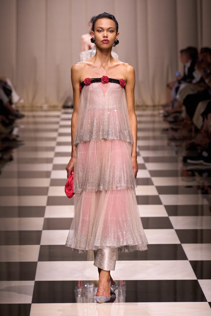 pink tiered midi dress with red bag