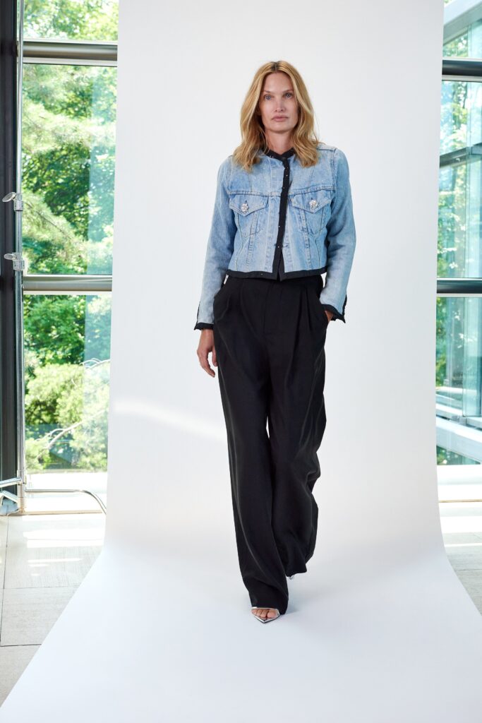 A relaxed blue denim jacket paired with relaxed black pants featuring a wide-leg silhouette.