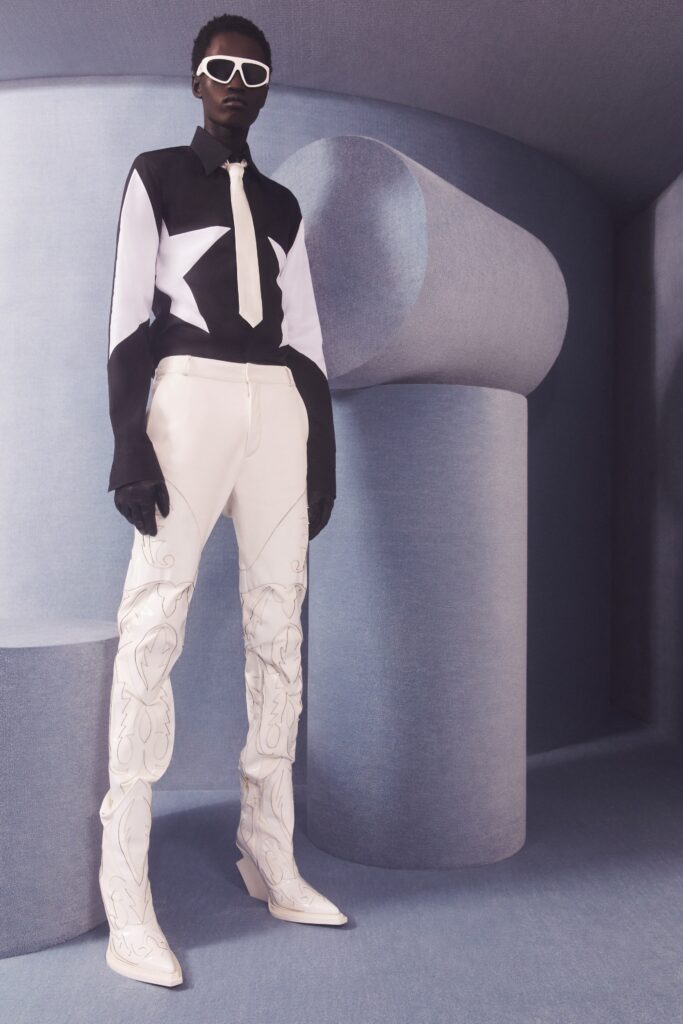 A fitted black and white long-sleeve shirt paired with stylish white pants.