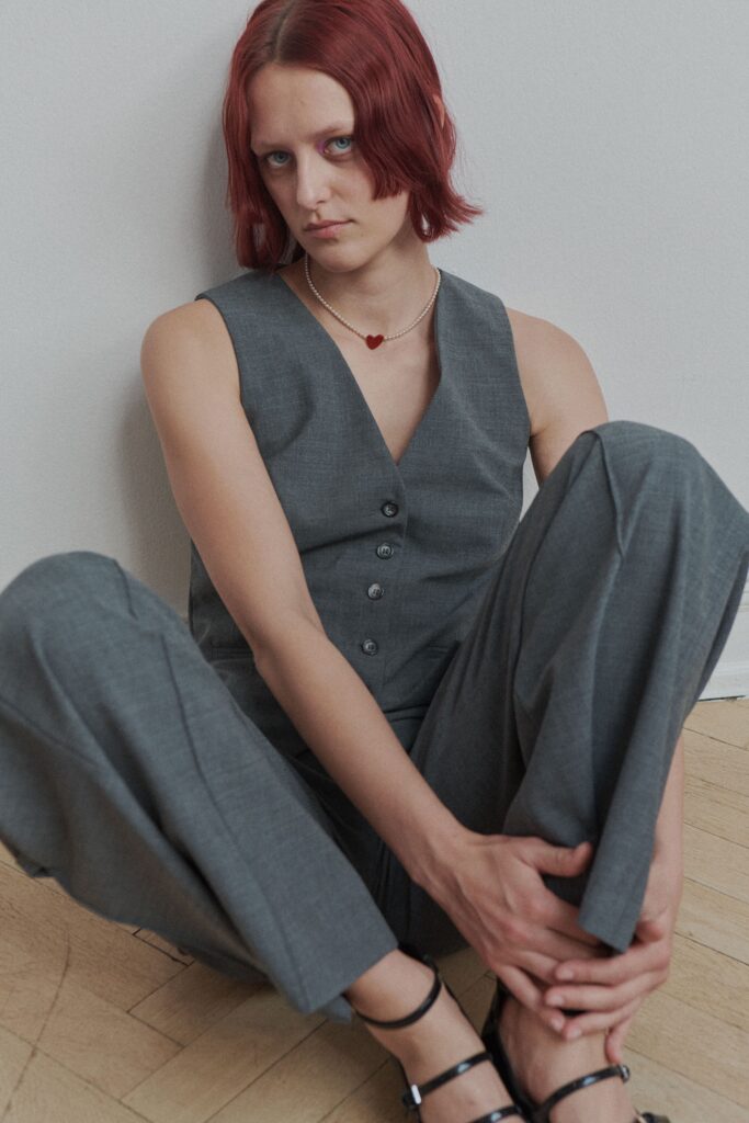 A relaxed gray cotton sleeveless jumpsuit with a collared neckline and wide-leg design.