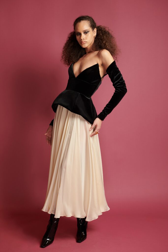 black velvet peplum top and beige pleated skirt