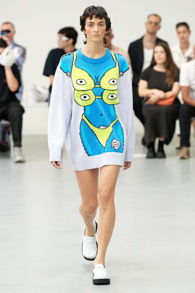 A relaxed blue sleeveless dress featuring a playful printed design.