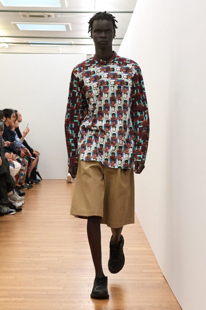 A relaxed-fit multicolor printed long-sleeve shirt paired with brown shorts.