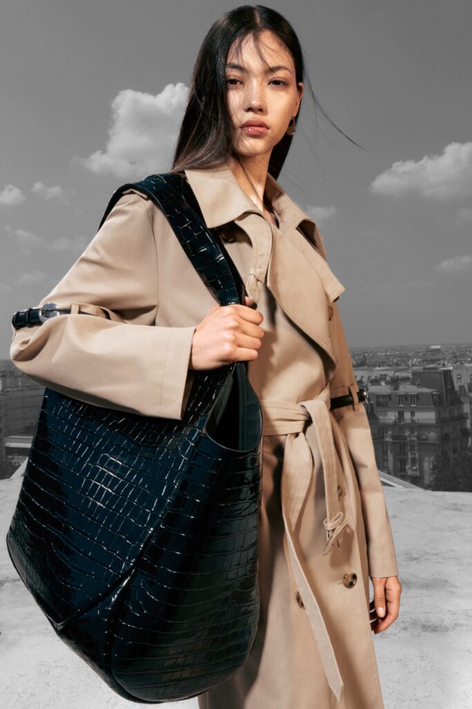 A relaxed beige coat with long sleeves and a collared design, featuring button details.